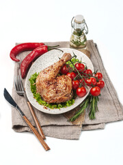food photography of baked (roasted) chicken leg in spicy tomato sauce (adjika) side view in ceramic plate on white background isolated close up