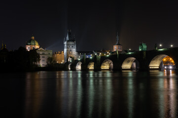 
street lights and light from him on the Charles Bridge from the 14th century on the Vltava river...