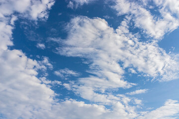 White clouds on a blue sky. The pattern of clouds. Clear weather