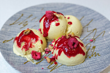 Pistachio ice cream balls with raspberry and berry sauce