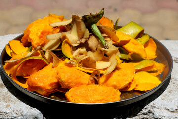 Mango and potato skin waste with seed in plate