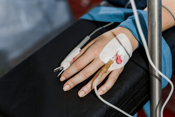 Pulse oximeter on woman hand for measuring oxygen saturation