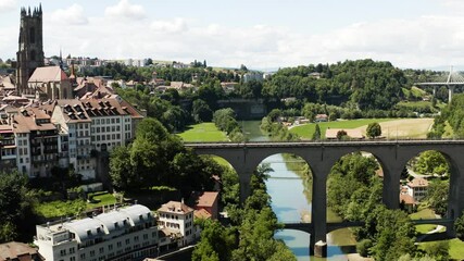 Aerial view of Fribourg town and its cathedral, Saint-Nicolas, Switzerland. Vue aérienne de la vieille ville de Fribourg filmée en drone, Suisse 4k.