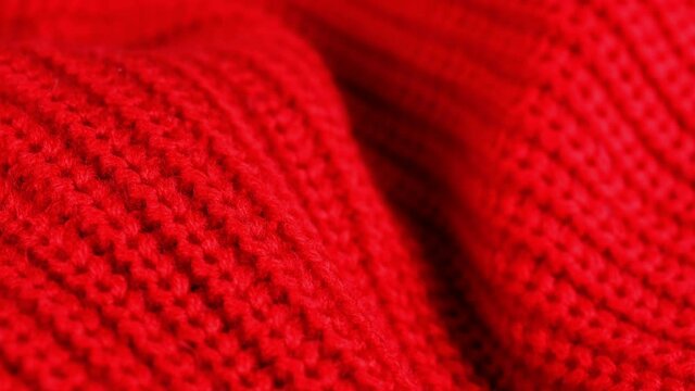 Woolen fabric texture. Red knitted fashion wool cloth closeup background. Winter textile industry macro 360 motion. 2 set of different shots.