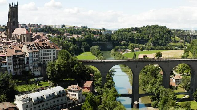 Aerial view of Fribourg town and its cathedral, Saint-Nicolas, Switzerland. Vue a&eacute;rienne de la vieille ville de Fribourg film&eacute;e en drone, Suisse 4k.