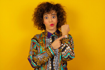 Beautiful young Caucasian woman over isolated background In hurry pointing to watch time, impatience, upset and angry for deadline delay