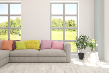 White living room with sofa and summer landscape in window. Scandinavian interior design. 3D illustration