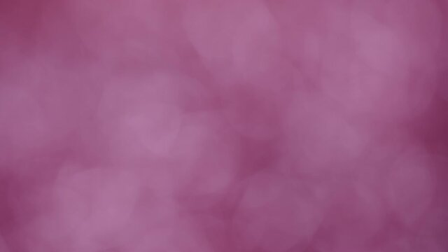 Abstract bokeh background. Purple pink violet joyful colors lens flare bokeh smooth motion backdrop.