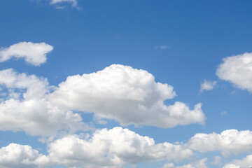 white clouds in the sky on a sunny summer day