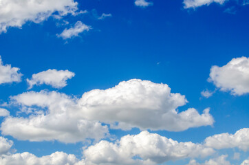 Naklejka na ściany i meble white clouds in the sky on a sunny summer day