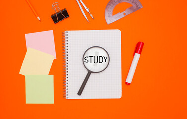 The concept of training and education. Three empty square notes, an empty checkered notebook, and office supplies on an orange background. The word 