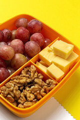 Food in Plastic containers ready to eat with Cheese, grapes and nuts