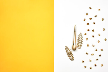 Golden eyeliner and many trinkets around on the bright colorful background. Make-up tool