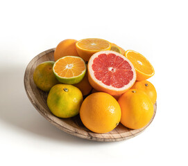 Wooden plate with fresh seasonal fruits isolated from the white background