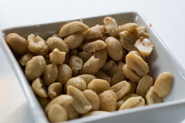 Close up of peanuts in a white bowl