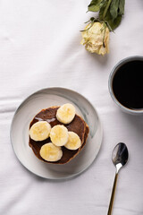breakfast in pastel: coffee with pancakes and banana
