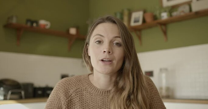 Female on video call with colleagues looking at camera, working from home during covid pandemic lockdown