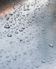 Water drops on a metal surface, background, shallow depth of field.