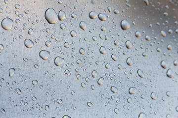 Water drops on a metal surface, background, shallow depth of field.