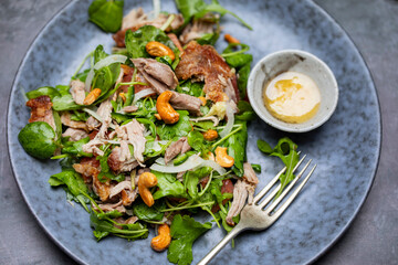 Salad with pulled duck, cashew nuts and grapefruit
