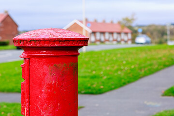 Fototapeta na wymiar Traditional iconic red Royal Mail British post box 