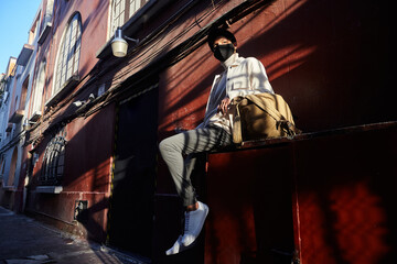Portrait Of Stylish young man wearing a face mask In The City