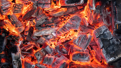 Hot coals are burning. Sparks from fire.