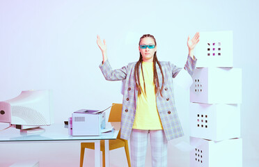 Stylish asian female office worker with obsolete computer in strange pose. Colored Neon light