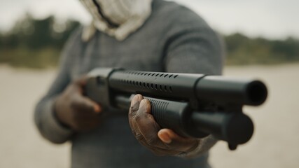Close up shot of a man pumping a shotgun. High quality photo