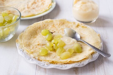 Crepes with grapes and pastry cream