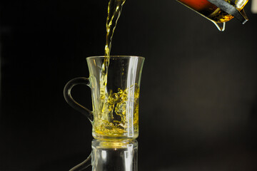 Tea being poured into a glass