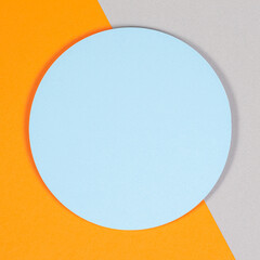 Abstract geometric texture background of soft light blue, pastel gray and orange color paper. Top view, flat lay