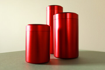 three metal red cans close up