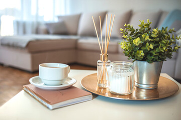Candle and aromatic reed freshener on table in spa salon. aroma liquid in glass bottle with reed sticks. aroma Diffuser In Luxury in bedroom. Hygge. Scandinavian home decor candles, fragrance, books