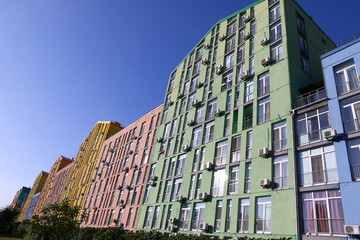Bright colorful houses of modern housing estate Comfort Town in Dniprovskyi district of Kyiv, Ukraine. Sunny day, blue sky background