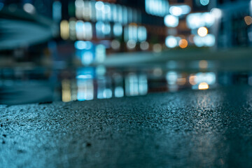 modern office building and glowing street lights and light reflections. After rain 