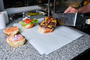 Man cooking hamburger in quarantine pandemic times