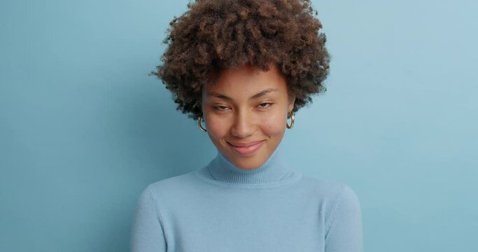 Attractive dark skinned female model has surprised face while talks with someone cannot believe in rumours looks bugged eyes at camera heard stunning news poses in casual wear indoor. Human reaction