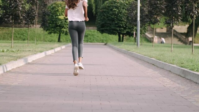 Shot of a fit young woman running in the park. Fitness, sport and healthy lifestyle concept