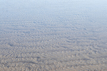 Textures made by water and wind on the sand at the beach