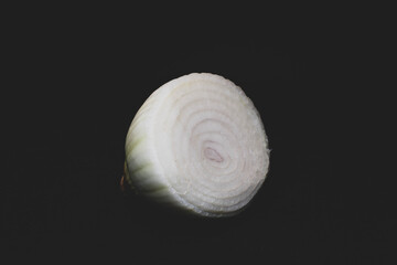 Fototapeta na wymiar a half of a onion with black background