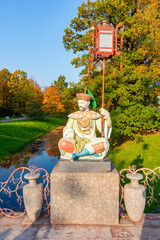 Sculpture on Large Chinese bridge in Alexander park in fall, Pushkin (Tsarskoe Selo), St....