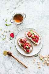 Sandwich with strawberries, soft cheese and honey