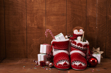Little knitted boots with Christmas gifts and various decorations
