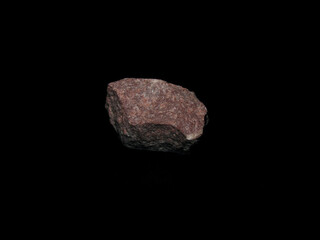 sample of crimson quartzite on a black background