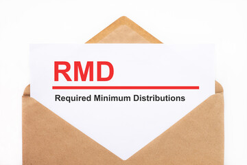 A white sheet with the text rmd lies in an open craft envelope on a white background with copy space. Business concept image