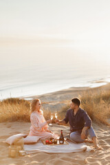 couple drinking champagne on the beach