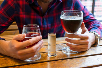 Alcohol in male hands in a bar close-up. The concept of alcoholism, the fight against alcohol addiction.