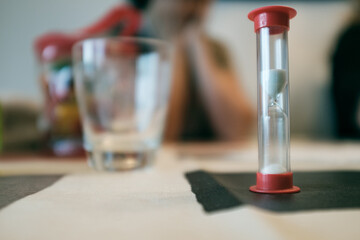 Red sand clock close up still on a dining table