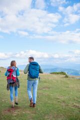 Fototapeta na wymiar Happy couple hiking and enjoying a valley view